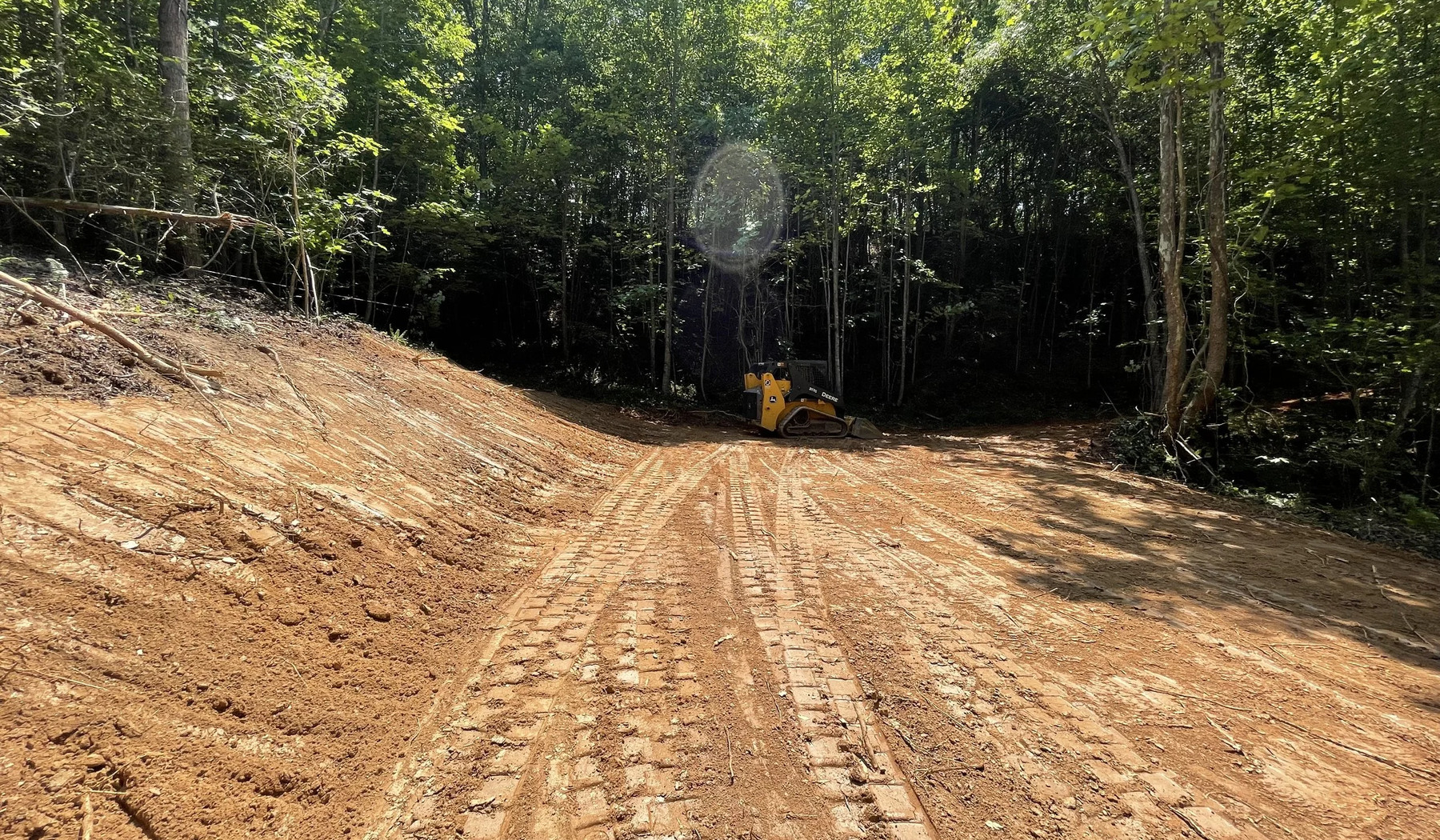 Access road and wooded path clearing with equipment in Kennesaw Georgia